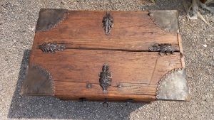 old wooden chest with metal hinges and metallic decorative details, handmade
