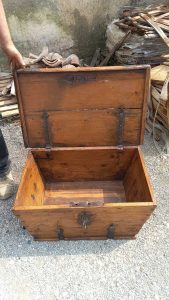 old wooden chest with metal hinges and metallic decorative details, handmade