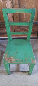 old wooden chair, in a vivid green color , handmade