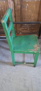 old wooden chair, in a vivid green color , handmade