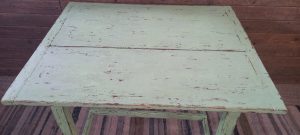 old wooden kitchen table , almost square , in a light green color , antique , vintage
