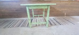 old wooden kitchen table , almost square , in a light green color , antique , vintage