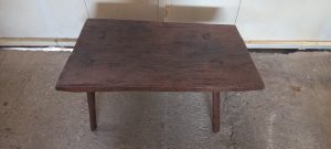 coffee table made by hand of old wood , short , slightly asymmetrical, restored ,  antique, vintage