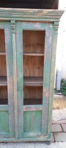 old wooden window case-bookcase ,green color, restored , handmade , curved on the top corners and the top part of the door