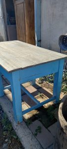 old wooden table, in a vivid blue color ,with a light colored table top and two drawers, hand made, restored, antique, vintage