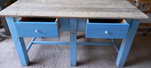 old wooden table, in a vivid blue color ,with a light colored table top and two drawers, hand made, restored, antique, vintage