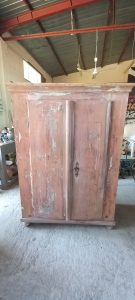 old wooden wardrobe, closet, , with two doors, in a light pink color, with a heavy, particular lock which also serves as a knob, handmade, restored