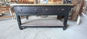 old wooden table-desk, workbench, industrial furniture, industrial design, in a dark color, with a light-colored top, two drawers and a light-colored shelf at the bottom part