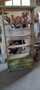 old wooden bookcase, book shelves, in a washed out green and natural wood color, restored, with four shelves and two deep drawers at the bottom, no back