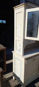 old wooden sideboard, kitchen furniture, with cupboards with windows on the top part of the furniture, drawers and storing space at the bottom (cupboards), in white color with leftover blue original color,