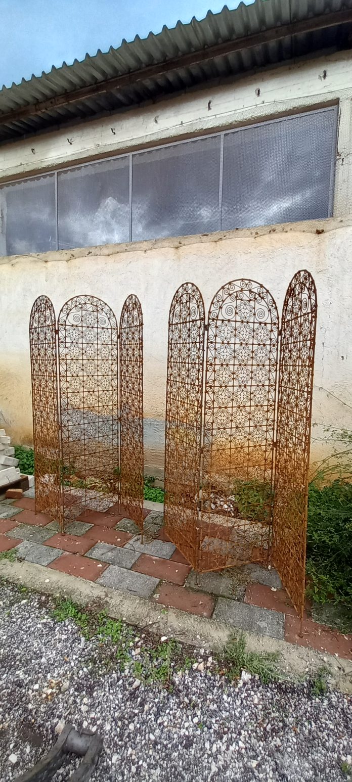 pair of old iron screens, old pair of folding screens out of cast iron, hand forged on fire, elaborately decorated with spirals, unique piece