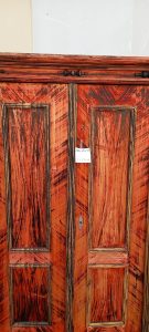 old wooden wardrobe in a vivid black-red color, old wooden closet, cupboard, white linen closet, vintage decoration