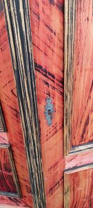 old wooden wardrobe in a vivid black-red color, old wooden closet, cupboard, white linen closet, vintage decoration