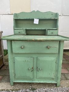 old wooden kitchen furniture in bright green color, kitchen cabinet, kitchen cupboard, side table, spice rack , handmade heavily built piece of furniture, vintage rustic decoration