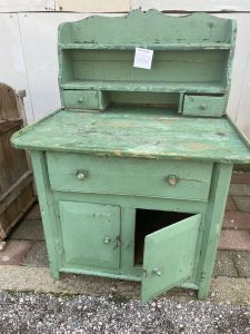 old wooden kitchen furniture in bright green color, kitchen cabinet, kitchen cupboard, side table, spice rack , handmade heavily built piece of furniture, vintage rustic decoration