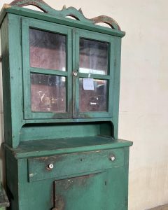 old wooden sideboard in a vivid green color, old wooden kitchen cabinet, cupboard, dish rack, spice rack, handmade, heavily built piece of furniture