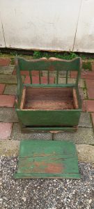 old wooden sofa-seat in green color, child's seat with storage under the seat, old wooden piece of furniture