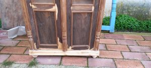 old wooden window case- bookcase  in a natural color of wood, old wooden storage piece of furniture with window, three horizontal curved columns and curving on the top part