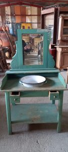 old wooden wash stand with a mirror and small drawers, old wooden table for porcelain bowl pitcher in turquoise color, handmade, with iron basin and curving on the side