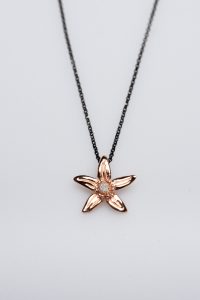 Necklace with the orange blossom in 925 silver rose gold plated with cubic zirconia in the center and black chain from black colored silver 925 (total length 44cms -17,328 inches)