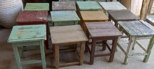 old wooden seats , stools in different colors, small seats ,old antique seats ,handmade , old handmade wooden furniture