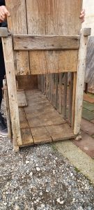 old wooden cage, antique wooden container for domestic animals , with handles so it can be moved easily and 2 doors on either side which slide upwards in order to open up, handmade house tool
