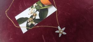 Necklace with the orange blossom in silver 925 gold plated with white enamel in the center (total chain length 50cm and 56cm)